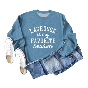 Flat lay of light blue crewneck sweatshirt with white Lacrosse is My Favorite Season print