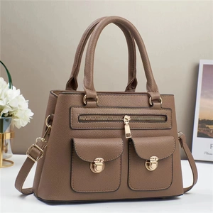 Brown litchi pattern leather tote bag with gold metal buckles and adjustable strap