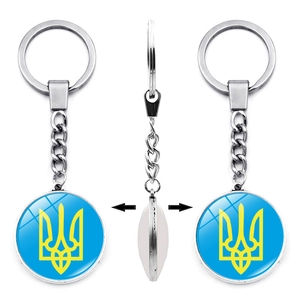 Detailed view of silver polished keychain with Ukraine national emblem on double-sided charm