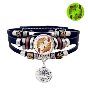 Detail of multi-layer leather Pisces bracelet with glowing glass charm and metal pendant