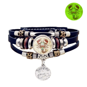 Detailed view of multilayer leather bracelet with Scorpio sign and luminous glass dome
