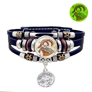 Detail of multi-layer leather bracelet with Capricorn zodiac pendant and wooden beads