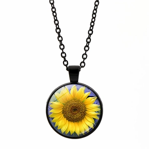 Close-up of sunflower pendant with glass dome and black link chain necklace