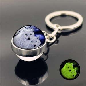 Luminous double-sided glass keychain featuring white wolves with a green glowing moon effect