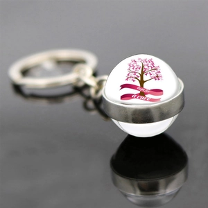 Detail of a glass dome keychain with pink ribbon tree and Hope for a cure inscription