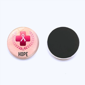 Macro view showing both sides of a 25mm pink ribbon HOPE magnetic fridge magnet