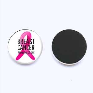 Macro view of magnetic breast cancer awareness fridge magnet with pink ribbon logo