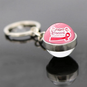 Pink ribbon breast cancer awareness keychain with glass dome pendant on black mirror