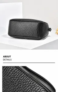 Dettagli della borsa in pelle granulata nera che mostrano texture e cerniera in metallo