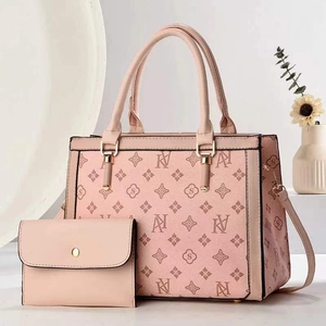 Close-up of pink printed tote bag set with detachable strap and matching mini wallet