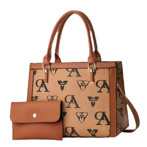 Two-piece printed crossbody bag set in brown faux leather with monogram flower patterns