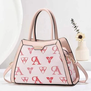 Detail of pink floral monogram crossbody bag with golden zipper and leather handles