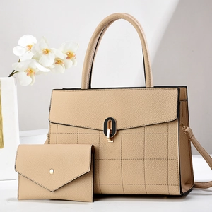 Detail of beige lychee texture leather tote and matching envelope wallet set