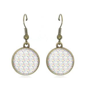 Detailed view of bronze hoop earrings with colorful retro polka dot glass cabochons