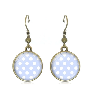 Detail of vintage bronze hook earrings with light blue polka dot glass pattern