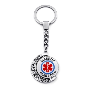 Detail of rotating medical alert keychain with diabetic alert dog sign and silver moon frame