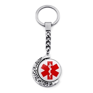 Detail view of double-sided rotating medical alert keychain with Star of Life symbol