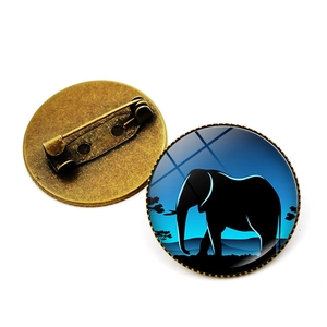 Detailed front and back view of a bronze elephant silhouette glass dome brooch