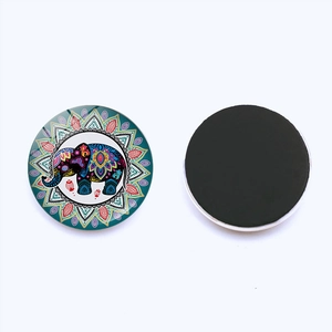 Detail of colorful elephant mandala fridge magnet showing front glass and back magnetic side