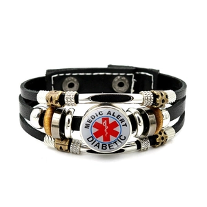 Macro detail of multi-layer leather bracelet with Medic Alert Diabetic badge and star of life