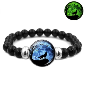 Luminous beaded bracelet with howling wolf moon charm and green glow effect view