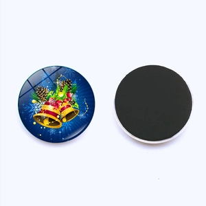 Detail view of 25mm Christmas bell glass fridge magnet with magnetic back on white background