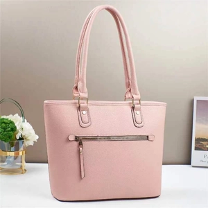 Detailed back view of pink bucket bag with functional zipper pocket and lychee leather texture