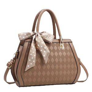Brown quilted faux leather tote bag with elegant silk scarf and gold hardware accents
