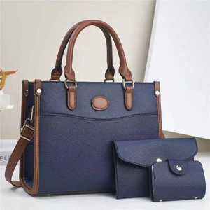Detailed set of deep blue tote bag with brown straps, matching wallet and card holder