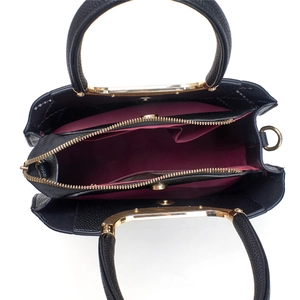 Top view of black tote bag interior with magenta lining and triple compartments