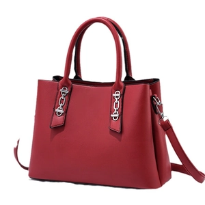 Deep red pebbled leather tote bag with silver chain accents and adjustable shoulder strap