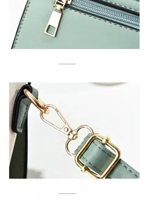 Detail of light green leather bag with gold-tone hardware and back zipper pocket