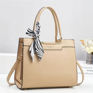 Detail of apricot bucket bag featuring litchi grain texture and a zebra print scarf