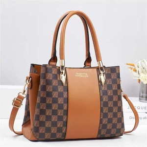 Chic color-block tote bag with checkerboard pattern and adjustable shoulder strap