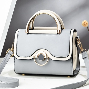 Chic blue and cream patchwork crossbody handbag with elegant metal top handle and PU leather