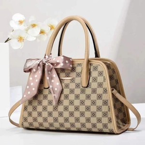 Chic beige checkered shoulder bag with clover motifs and decorative pink silk scarf