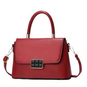 Minimalist burgundy leather handbag with black square buckle on white background