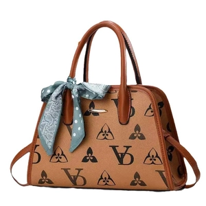 Classic monogram shell handbag with leather handles and decorative polka dot scarf