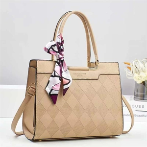 Chic quilted beige shoulder bag with decorative floral scarf and premium hardware