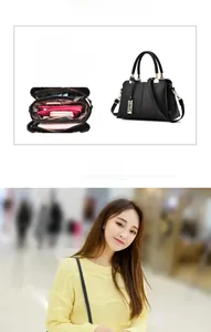 Macro detail of spacious interior compartments and gold leaf pendant on black tote bag