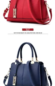 Detail view of burgundy and navy litchi texture leather handbags with gold hardware