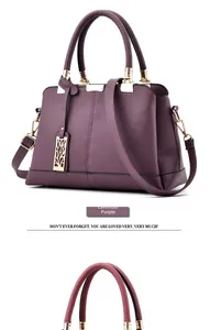 Detailed view of Taro Purple lychee leather tote bag with gold metal pendant and handle