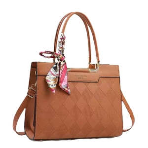 Quilted caramel brown tote bag with floral silk scarf and gold metal hardware accents