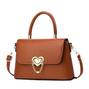 Fashionable caramel brown leather handbag with gold heart buckle and chain strap