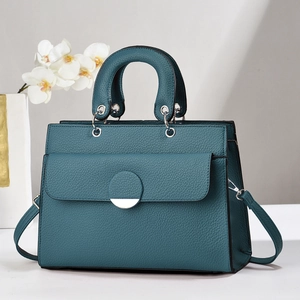 Elegant peacock green leather handbag with lychee pattern and circular metal clasp