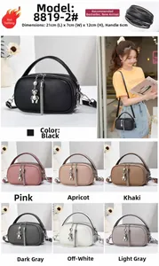 Detail view of multi-layer pebble leather bag with bear charm and long tassel