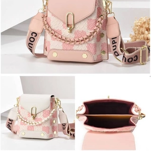 Checkered pink and white woven crossbody bag with metal buckle and wide logo strap
