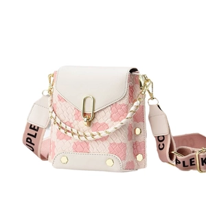 Quilted mini crossbody bag with pink woven texture and adjustable wide fabric strap