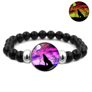 Luminous howling wolf moon black beaded stretch bracelet with glowing green effect