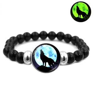 Luminous howling wolf bracelet with black beads and silver accents glowing in the dark